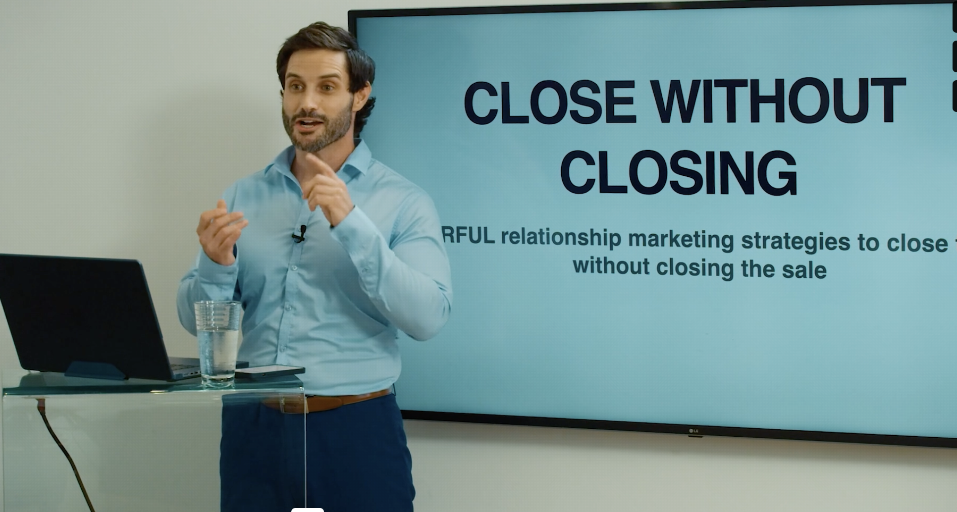 Patrick training a room in front of a Close Without Closing presentation slide